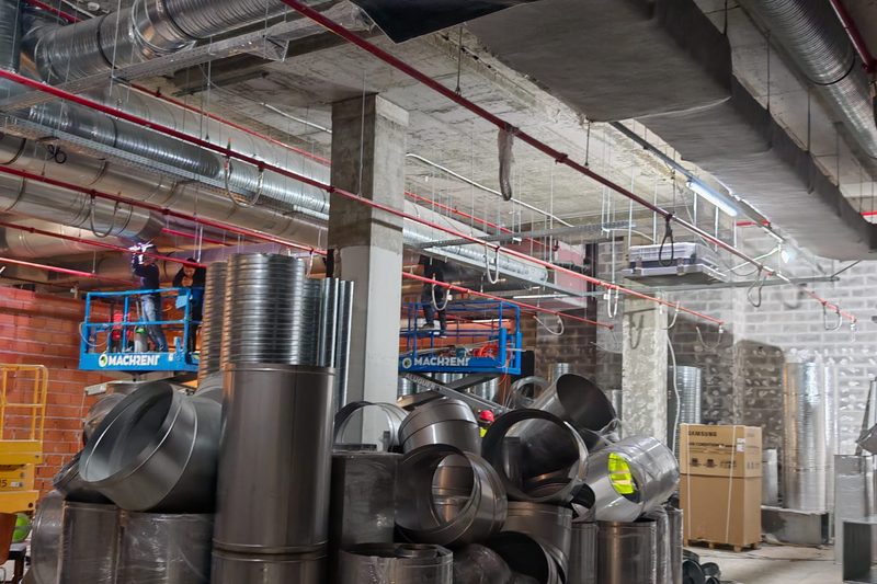 Ventilation ducts and fittings stored on site, before installation